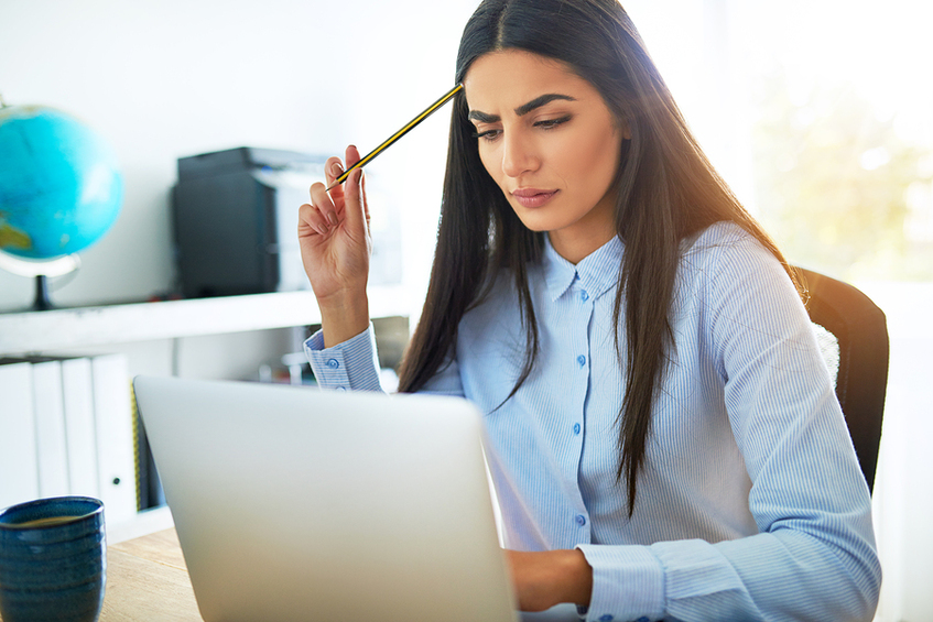Woman working on a laptop computer.